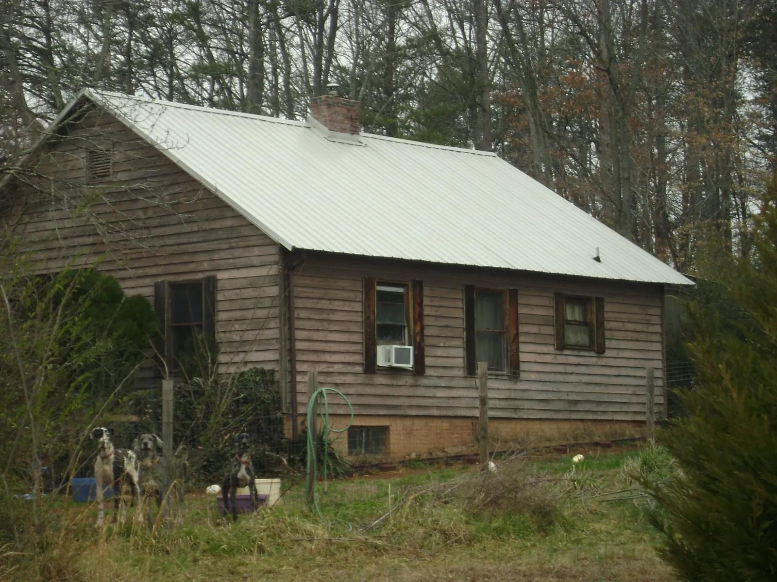 White metal roof on an old wood sided farmhouse, from a Metal Roof Installation job in Carolina